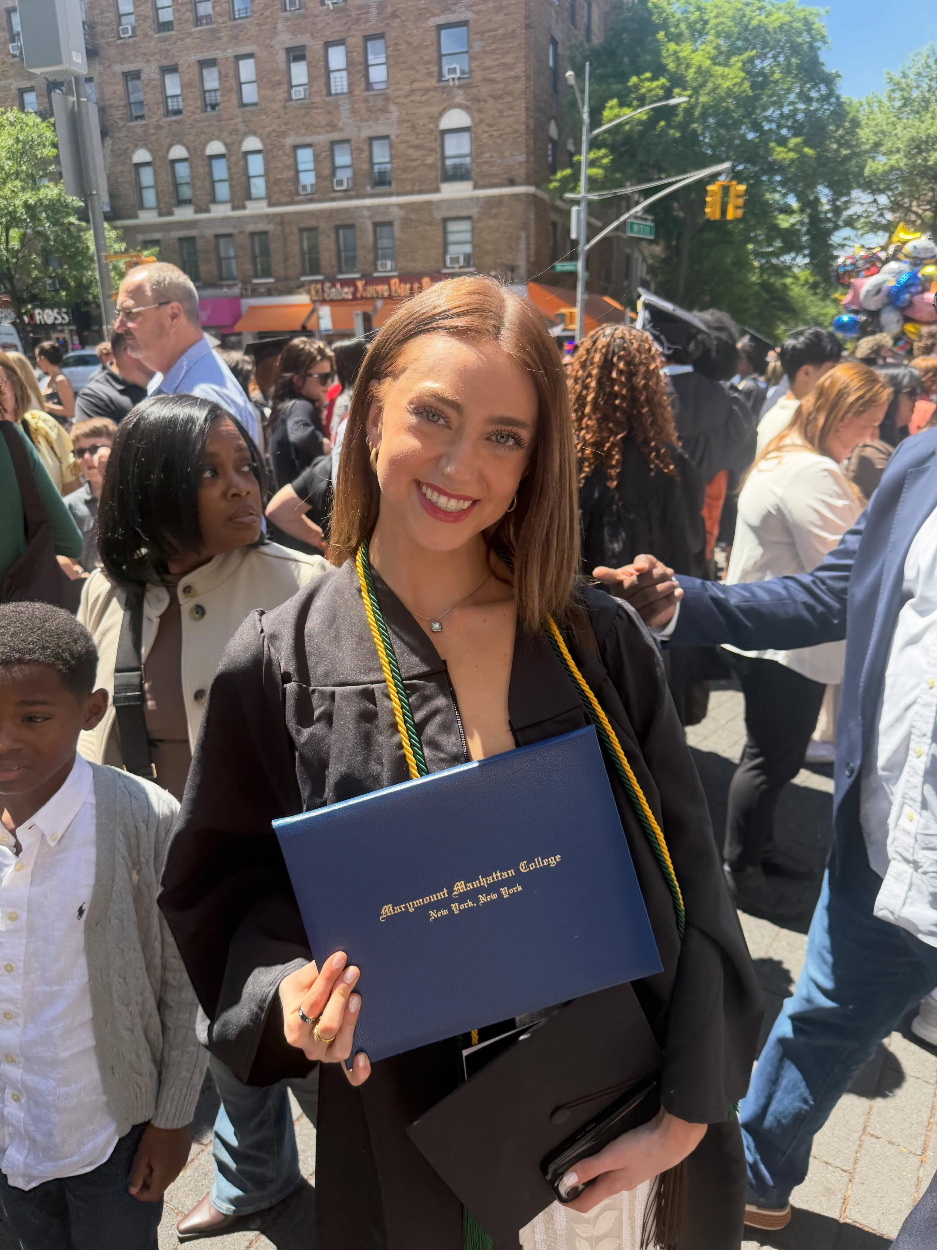 Christina at Marymount Manhattan College graduation with diploma